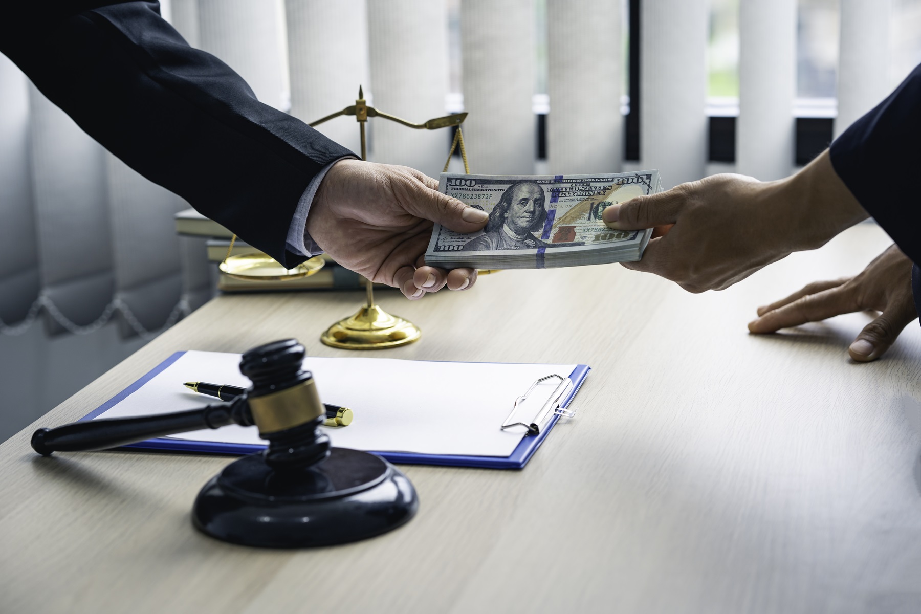 Attorney providing pre-settlement funding to a client, with scales of justice and a gavel