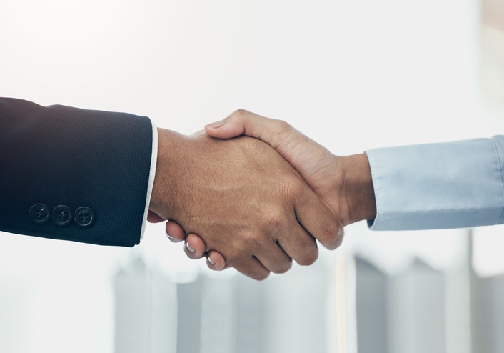 Attorney and client shaking hands, representing a trusted funding partnership